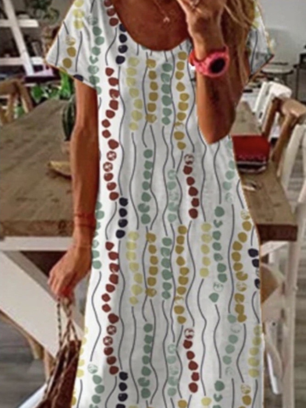 Misslook graphic print maxi t-shirt dress features a distinctive gold, teal,